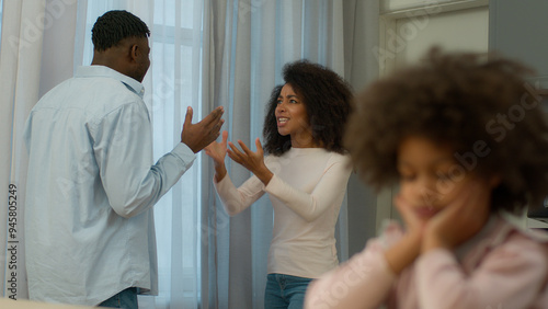 African American family problem quarrel conflict arguing parents angry man father male husband argue yelling screaming mad woman female mother domestic violence upset little child kid girl daughter