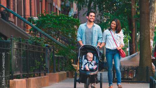 Family Day Out With Dad Pushing Baby In Buggy As They Walk Along Urban Street In New York City USA