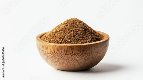 Heap of garam masala spice blend in a small wooden bowl, with a light dusting around it on a white background, no people.