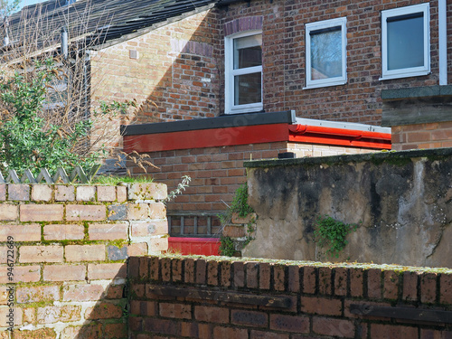 view of a back alley from a yard with brick walls in a typical old english working class terraced street