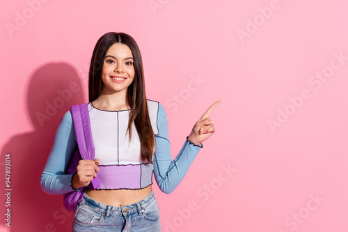 Photo of lovely cute college schoolgirl wear stylish clothes recommend empty space offer isolated on pink color background