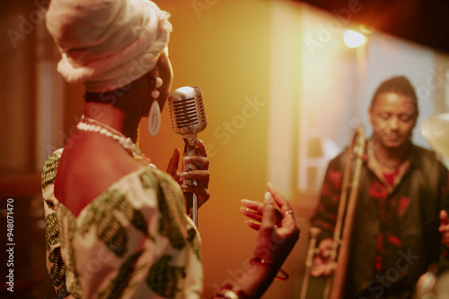 Unrecognizable young Black woman singing ballad on stage with her jazz band, copy space