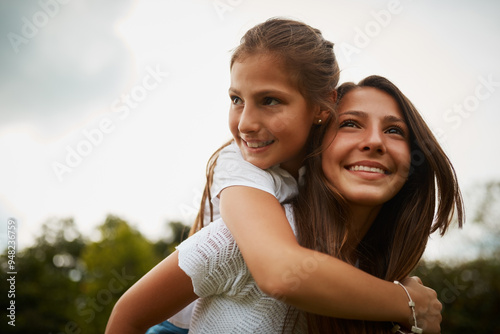 Outdoor, piggyback and sister with smile, child and bonding in nature, thinking and happy in forest. Love, girls and fun in woods, carrying and teenager with care for kid, siblings and contemplating