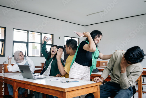 Group Of Asian Multiethnic Students Making Chaos In Classroom