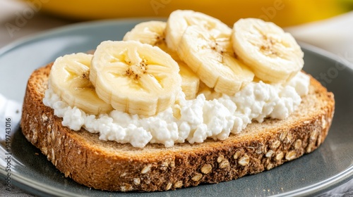 Healthy breakfast featuring whole grain toast topped with creamy cottage cheese and fresh banana slices for a nutritious start.