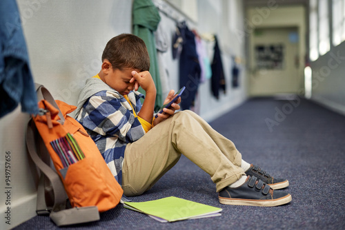 Depressed school boy being cyber bullied