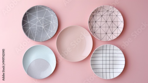 Five stylish, geometric-patterned plates arranged on a pastel pink background, elevating tableware with modern aesthetics.