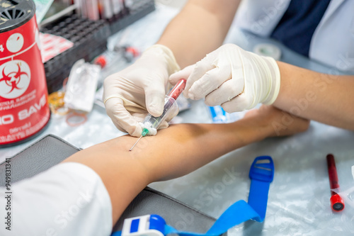 Close up hand of nurse, taking blood sample from a patient in the hospital. 