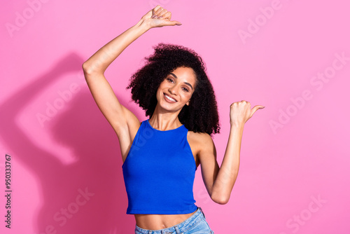 Photo portrait of attractive young woman point empty space dressed stylish blue clothes isolated on pink color background