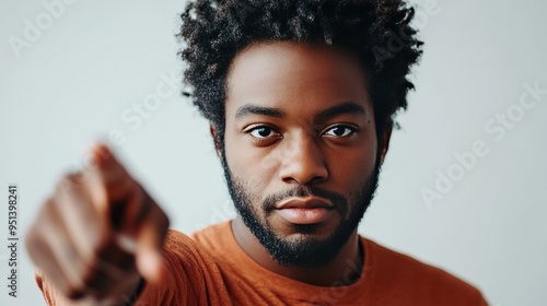 Confident African man poses in studio.