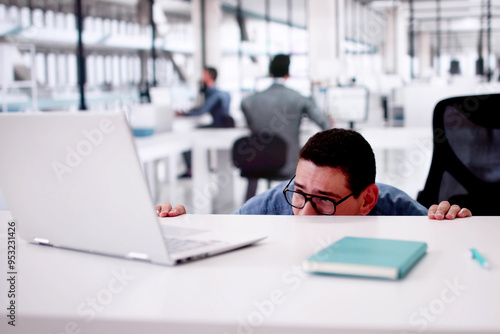 Hiding Behind Desk In Office