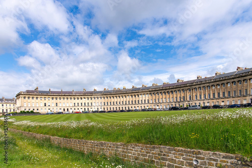 Lawn with wildflowers in front of The Royal Crescent terraced houses Bath, Somerset, UK by architect John Wood, the Younger and built between 1767 and 1774 in Georgian architecture