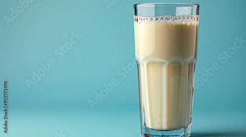 Glass of Fresh Milk Against Blue Background - Refreshing Dairy Drink in Clear Glassware