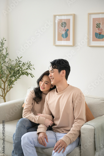 Portrait of young asian couple sitting in living room at home