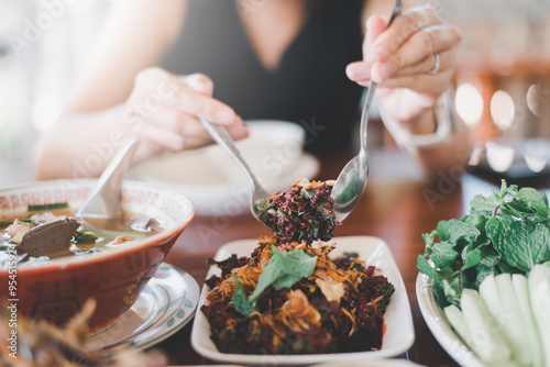 Woman eating thai raw beef salad with blood,Unhygienic food concept