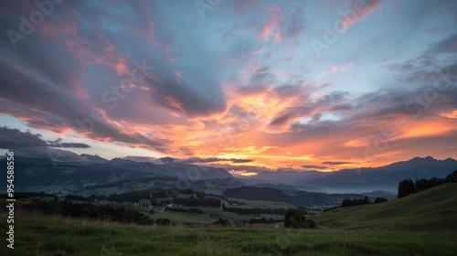 Sunset in the Alps mountains, showcasing a beautiful cloudscape with hues of orange, pink, and purple