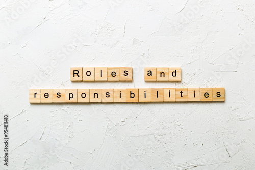 roles and responsibilities word written on wood block. roles and responsibilities text on table, concept