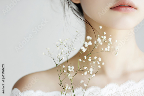 Woman's delicate collarbone adorned with tiny flowers