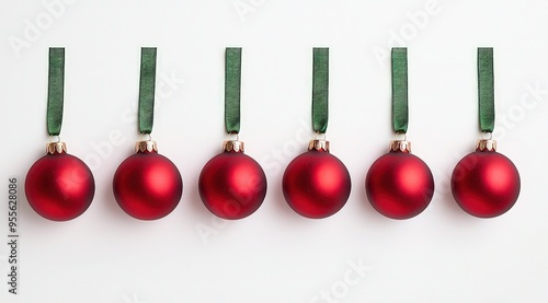 Christmas Ornaments in Red Hanging on Green Ribbons, Flat Lay Style.