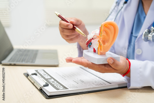 A female doctor sits at a table in a hospital, discussing hearing loss, tinnitus, and balance problems like dizziness and vertigo, addressing issues such as ear infections and inner ear degeneration.