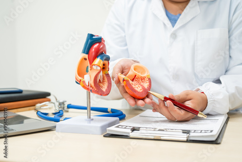 A female doctor works at a desk in the hospital,discussing heart diseases such as coronary artery disease,arrhythmia,heart valve stenosis,heart failure congenital heart disease, emphasizing symptoms