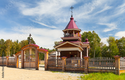 View of wooden Church of Holy Trinity 1915 from Dyadino village, restored 2019 in Taltsy open-air architectural and ethnographic museum in summe sunny day. Beautiful wooden Siberian architecture