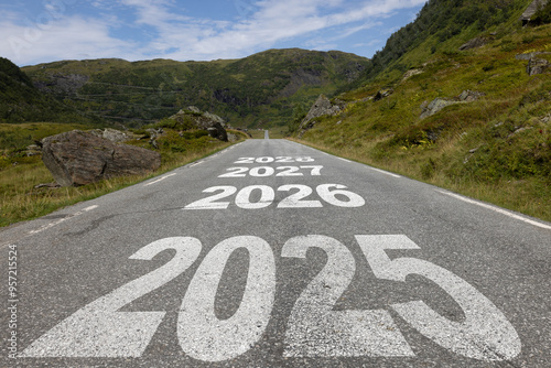 New year 2025 or straight forward concept. Text 2025, 2026, 2027, 2028 written on the road in the middle of asphalt road with at sunset. Concept of planning, goal, challenge, new year resolution. 