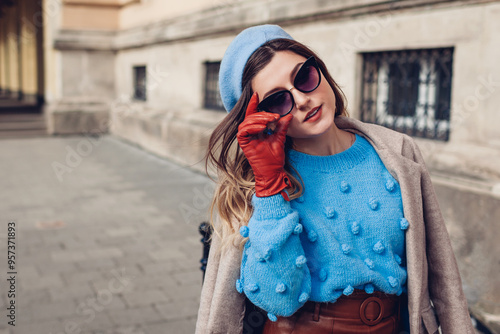 Autumn vintage retro fashion female accessories and clothes. Woman wearing sweater beret leather skirt on street.