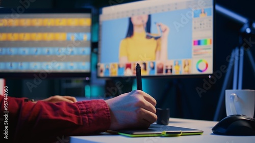 Photo editor editing images, doing color correction in post production company using graphic tablet. Photographer fixing overexposed pictures with stylus on touchscreen device, close up shot