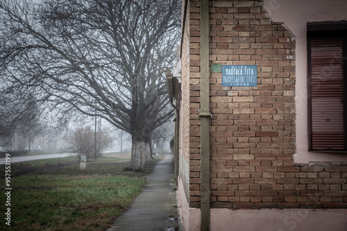 Selective blur on Bilingual street sign Ulica Marsala Tita in Serbian & Maresalul tito strada in Romanian meaning Tito Street obeying biligual minority laws in Serbia. Tito is former communist leader.