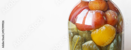 spoiled can of vegetable seaming with homemade pickled tomatos and cucumbers