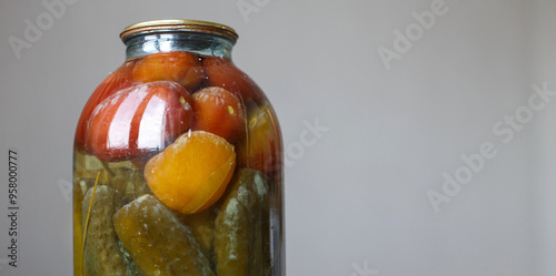 spoiled can of vegetable seaming. Glass jar with pickled tomato's and cucumbers