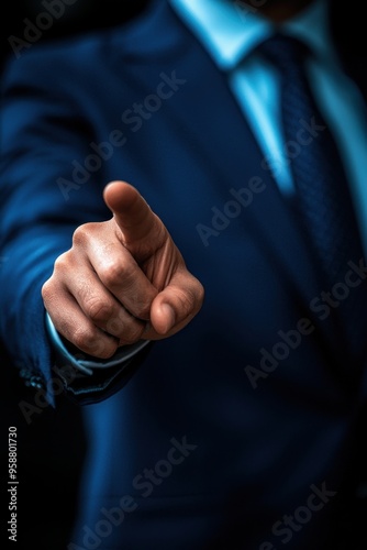 Close-up of a person in a suit pointing their finger towards the camera, conveying authority, direction, or accusation.