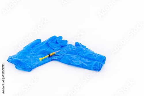 A syringe with the anticoagulant drug Clexane in the hand of a doctor wearing a blue rubber glove