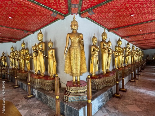 Buddha statue in Wat Pho Temple, Bangkok, Thailand. Series of Lord Buddha replica sitting on a crafted gem stones, with intricate colorful ornaments