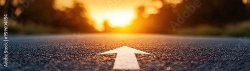 Asphalt road with white arrow leading forward, warm light from sunset, symbol of progress, journey through life