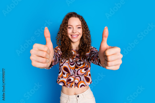 Photo portrait of attractive young woman thumb up approve dressed stylish colorful clothes isolated on blue color background