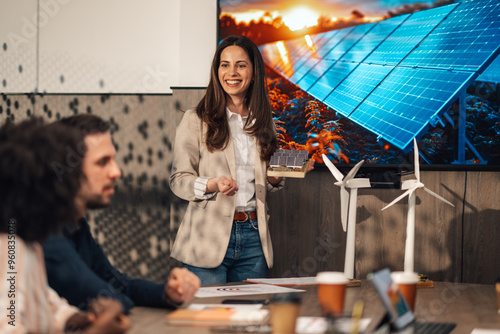 Businesswoman with solar panels model having presentation at office.