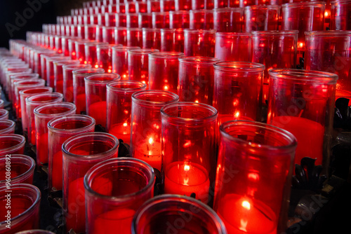 Rows of red votive candles offer their prayers to God.