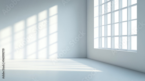 A clean, white room with sunlight streaming in through the window, casting shadows on an empty wall