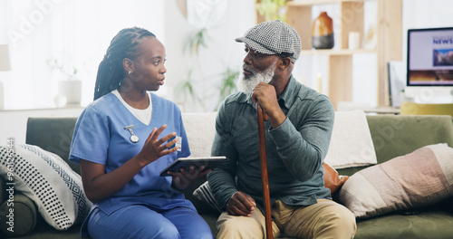 Healthcare, tablet and senior man with nurse, explaining and caregiver with advice and nursing home. Living room, medical and black people in house, talking and remote monitoring of patient or health