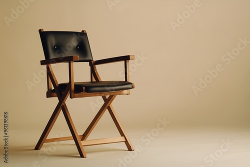 A stylish wooden director's chair with black leather seat and backrest, set against a clean beige background.