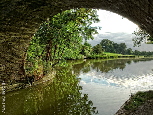 old bridge over the canal in England with reflections in the water