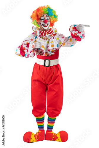 Funny clown pointing at blank template copy spase for advertising, posters, greetings, invitations. Entertainer as Joker in a suit and wig, with clown whiteface makeup.