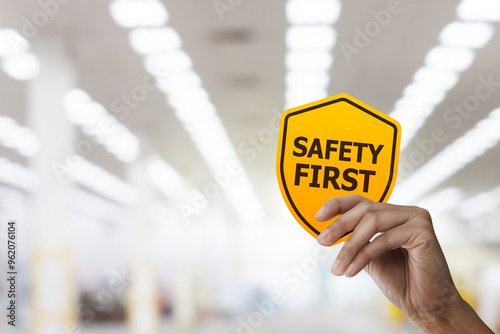 Hand holding safety first symbols for work safety, Safety first concept.