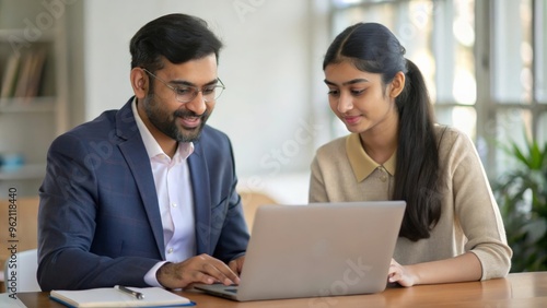 An Indian male teacher advising university student girl on career options, with resources and guides available for exploration.