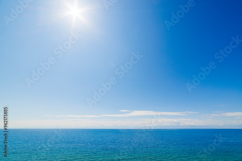 large open water surface with far snowcapped mountain range on the horizon at sunny day.