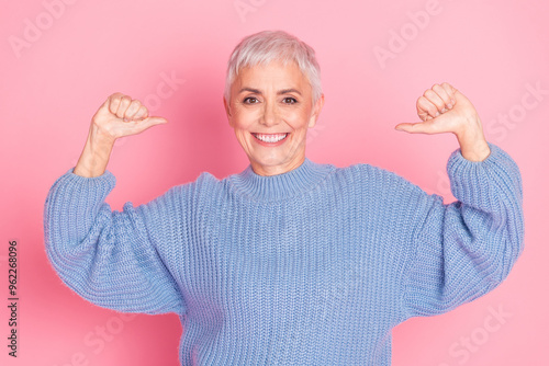 Photo portrait of attractive senior woman point self proud dressed stylish blue knitwear clothes isolated on pink color background