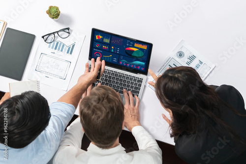 Top view workspace of analyst team uses BI Fintech display laptop to analyze financial data . Business people analyze BI software technology dashboard power for insights business power. Prudent