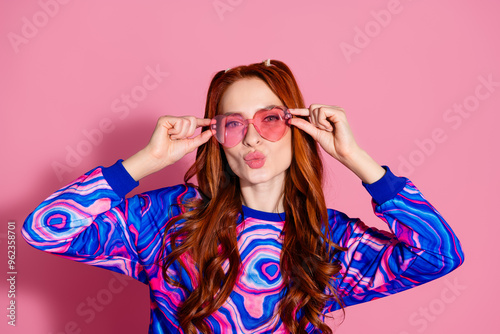 Photo of flirty girl touch her sunglass send air kiss isolated pastel color background